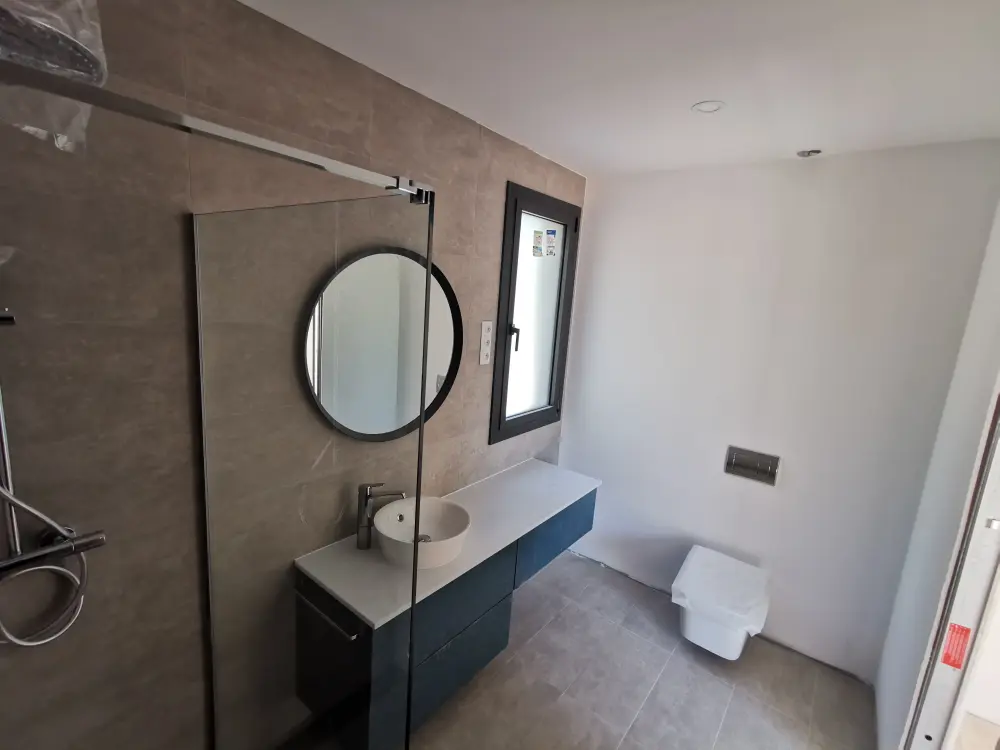 Completed bathroom with coordinated finishes in Castellnou de Bages